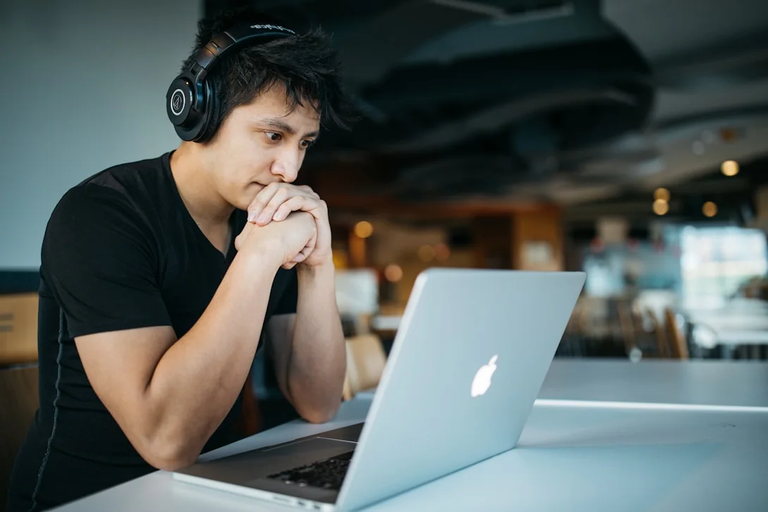 Learner studying on a laptop with headphones